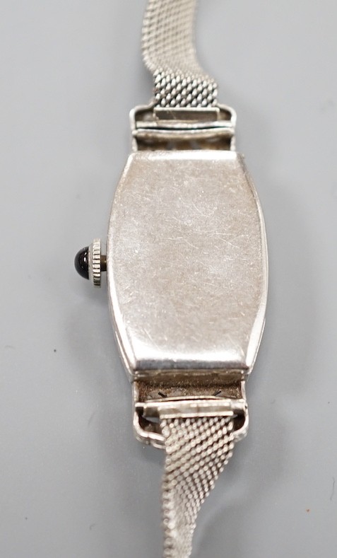 A lady's white metal (stamped plat) and diamond set cocktail watch, on a 9ct mesh link bracelet, overall 18cm, gross weight 17 grams.